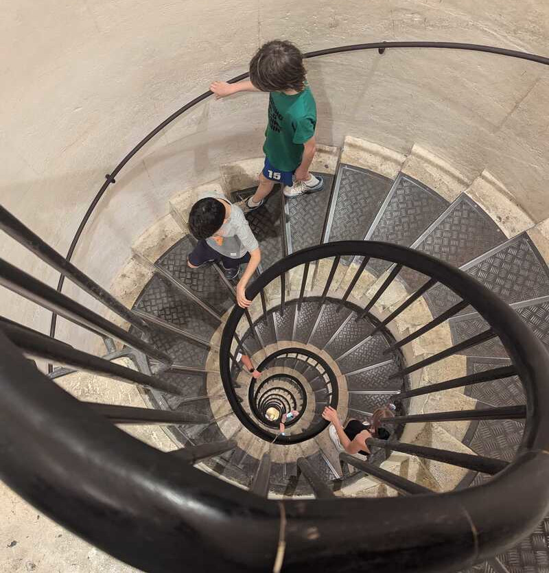 Jake and Miles descending the steps inside the Arc de Triomphe