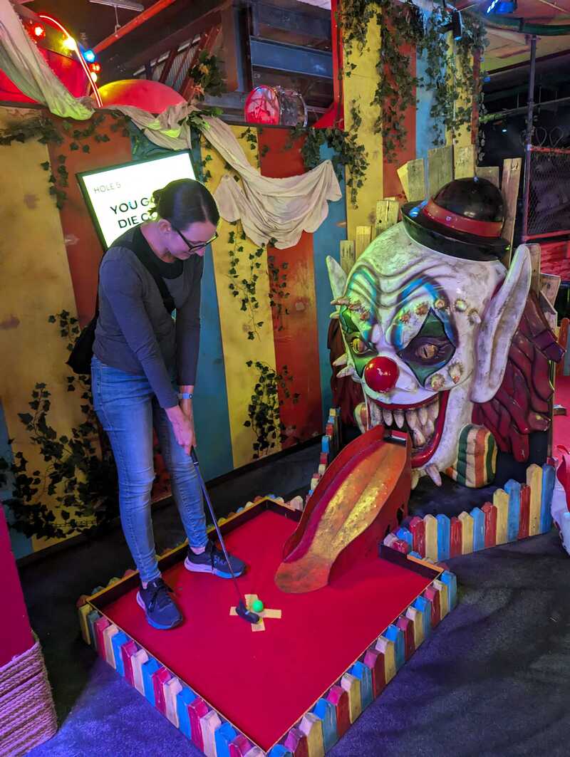 Sonia putting a ball into the mouth of an evil-looking clown